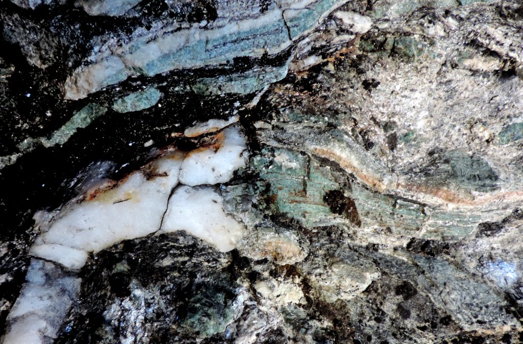 04. Noduli e lenticelle di giadeite strettamente associata a quarzo sulle pareti rocciose sotto Breil.